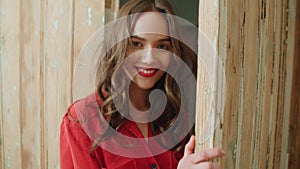 Portrait of young pretty brunette woman smiling at home.