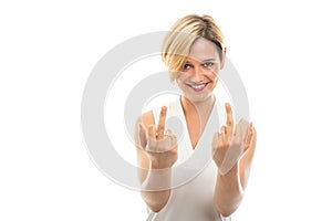 Portrait of young pretty business woman showing obscene gesture