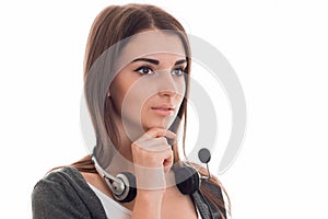 Portrait of young pretty call center worker girl with headphones and microphone looking away isolated on white