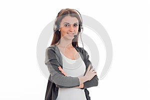 Portrait of young pretty call center worker girl with headphones and microphone posing isolated on white background