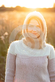 Portrait Of Young Pretty Caucasian Happy Girl Woman In Woolen Jacket Blouse And Brown knitted bonnet Posing In Early