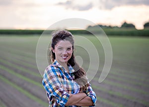 Portrait of young pretty farmer girl in field