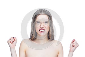 Portrait of a young pretty girl who clenched her fists in a fit of rage and anger, isolated on white background