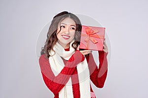 Portrait of young, pretty and happy woman with christmas gift box