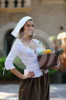 Portrait of young pretty peasant girl outdoors
