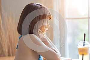 Portrait of young pretty sexy Asian woman wearing blue bikini in her room