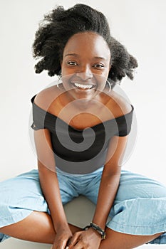 Portrait of a young pretty smiling african american woman looking happily at the camera on white background. Black lives metter,