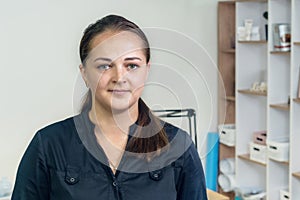 Portrait of a young pretty smiling girl in the office