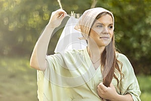 Portrait of young pretty white woman hanging up