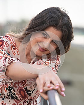 Portrait of a young pretty woman in casual summer clothing smiling happy at the beach.