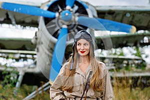 Portrait of a young pretty woman in a helmet and pilot`s suit