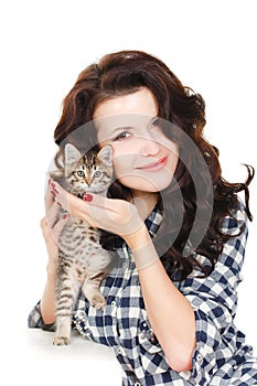 Portrait of a Young pretty woman holding her lovely little cat isolated on a white background