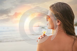 portrait of young pretty woman at sunset beach