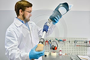 Young Prosthetist Holding Artificial Leg