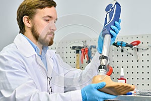 Young Prosthetist Holding Artificial Leg