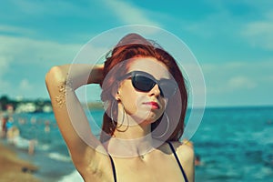 Portrait of a young red-haired woman on the sea