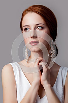 Portrait of young redhead woman with breautiful earrings