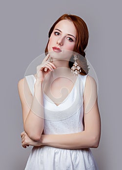 Portrait of young redhead woman with breautiful earrings