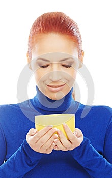 Portrait of a young redhead woman holding a mug