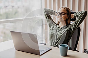 Portrait of young relaxed business woman in office