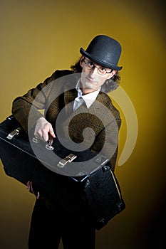 Portrait of young retro gentleman with luggage photo