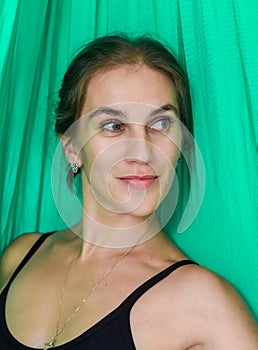 Portrait of young russian woman 31 year old looking side against green background