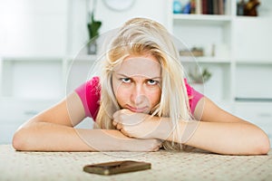 Portrait of young sad girl waiting for call