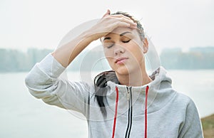 Portrait of a young sad woman with headache, fatigue or cold. D