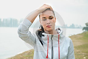 Portrait of a young sad woman with headache, fatigue or cold. D