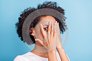 Portrait of young scared afraid frightened african girl cover face with hands stressed  on blue color background