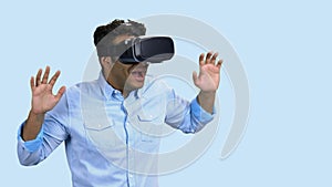 Portrait of young scared man using virtual reality glasses.