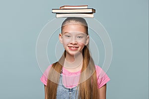 Portrait of a young schoolgirl with books