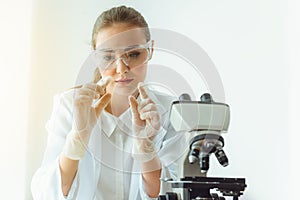 Portrait of young scientist research is looking at the microscope slide in the laboratory room, Biotechnology, Science, Chemistry