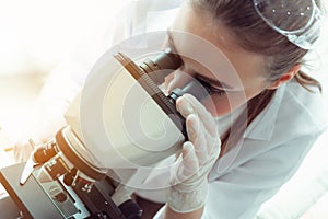 Portrait of young scientist research using microscope in a labor