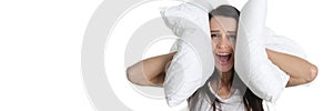 Portrait of young screaming woman covering ears with pillow