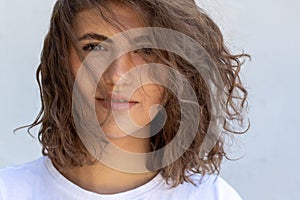 Portrait of young sensual woman with curly hair isolated on white background