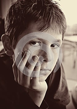 Portrait of young serious boy reflecting