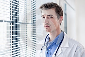 Portrait of a young serious doctor looking at camera with determination