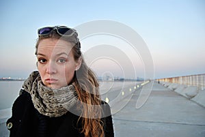 Portrait of young serious teen girl in scarf.