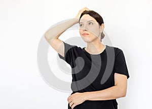 Portrait of young serious woman in black T-shirt looking up