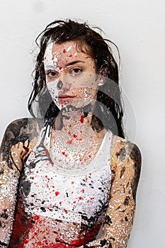 Portrait of a young and sexy Woman in underwear, sportswear, abstract painted with white, red and black paint, bodypainting