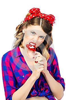 Portrait of young woman with vintage make-up and hairstyle with lollipop