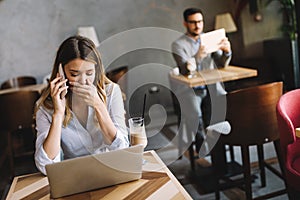 Portrait young shocked business woman sitting in front of laptop computer