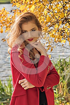 Portrait of a young shy coy girl in autumn