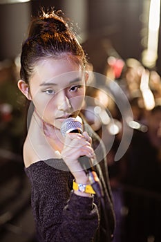 Portrait of young singer performing at music festival
