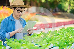 Portrait of young smart farmer using digital tablet computer for inspecting. using technology in agriculture field application in