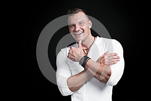 Portrait of young handsome man on dark studio background