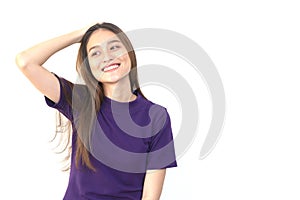 Portrait of a young smiling Asian woman pushing her hair back wi