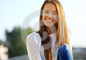 Portrait Of Young Smiling Beautiful Woman. Close-up portrait of a fresh and beautiful young fashion model posing outdoor