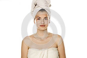 Portrait of young smiling beautiful woman with towel on her head